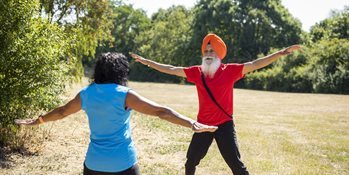 Man wearing a turban and woman doing star