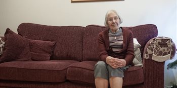 Older lady sitting on a sofa
