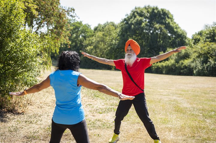 Man wearing a turban and woman doing star