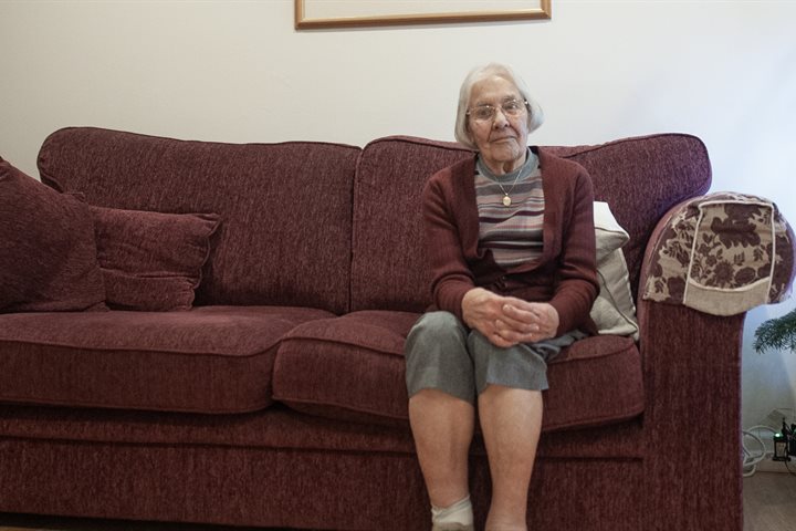 Older lady sitting on a sofa